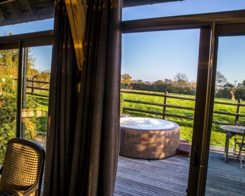 Vue du salon sur le jacuzzi, la Vie de Cocagne, gite de charme Normandie